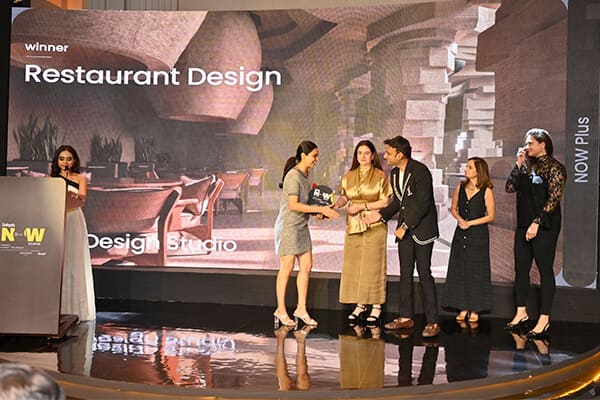 Winner of Restaurant Design receiving trophy