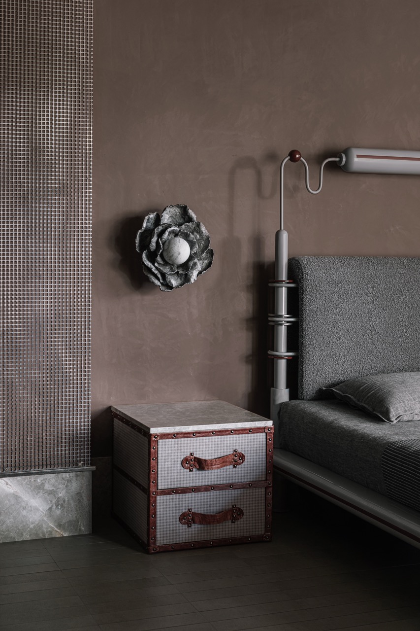 Each bedroom displays unique detailing, like this flower-shaped bedside light