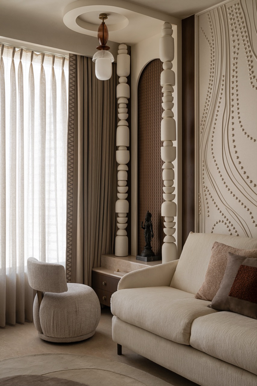 A well-planned space, the guest room has a sofa-cum-bed, and mandir area with a customised glass ceiling light by Jade and totems by Harshita Jhamtani Designs