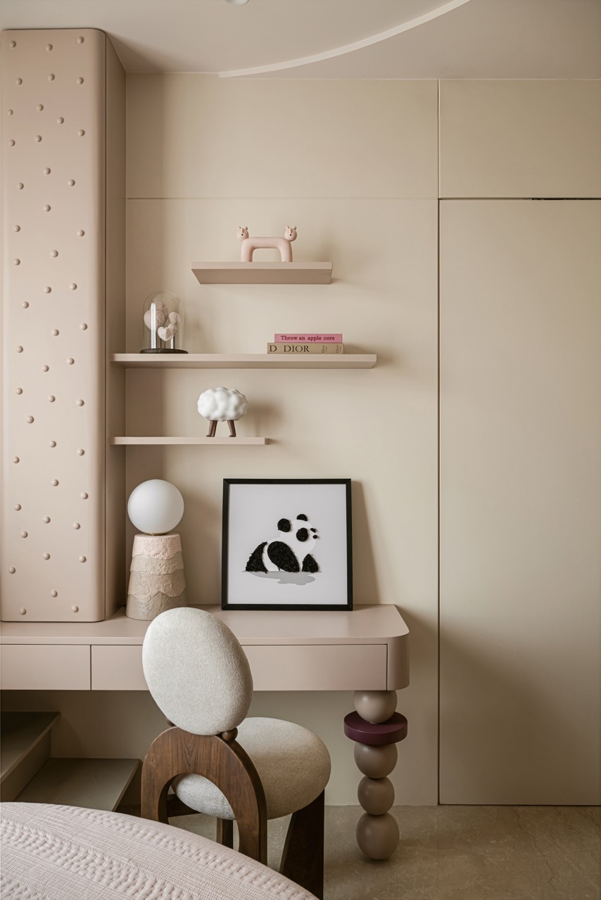 The playful desk and dotted cabinet in the daughter’s room are rendered in a pale clay pink
