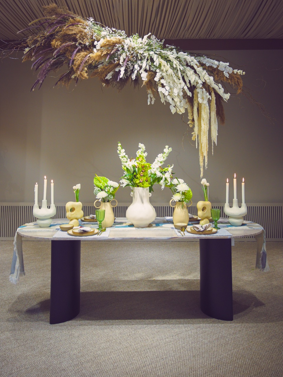 A tablescape for The Pure Concept Home explores a subtle, neutral palette, offering a take on minimal, understated opulence