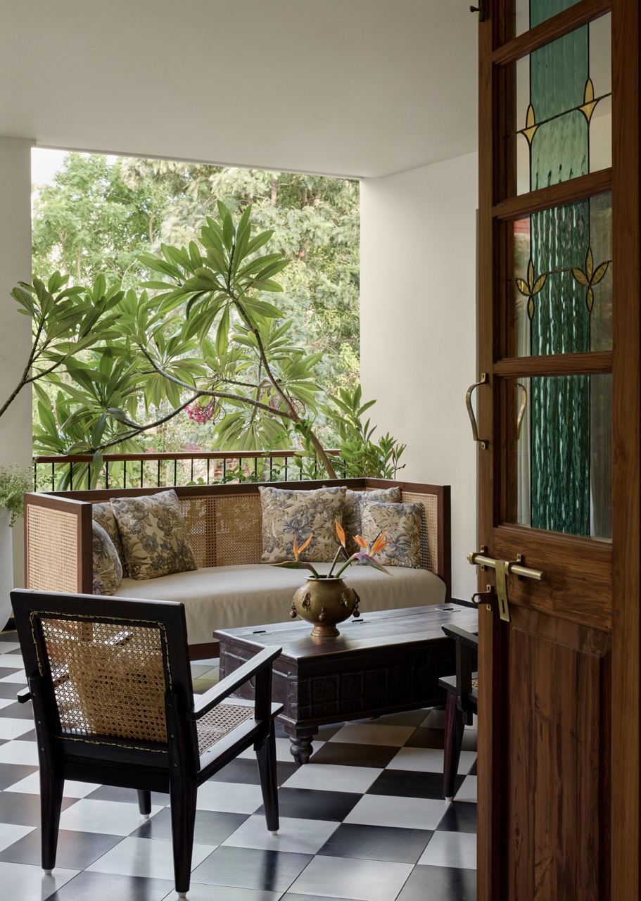On the first-floor sit-out, refurbished ancestral furniture is softened by Cottons and Satins cushions. Sunlight dances through stained glass panels, while brass artefacts from the clients’ collection gleam with quiet charm