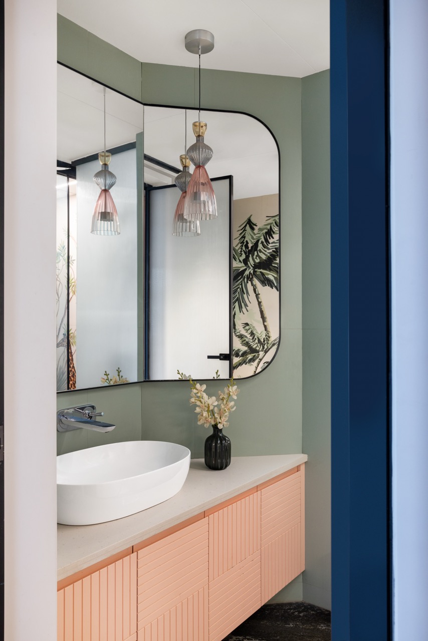 A calm bathroom setting is layered with wall tiles by Osaanj, a Hansgrohe faucet, an Azzura Italy sink, by Bathline