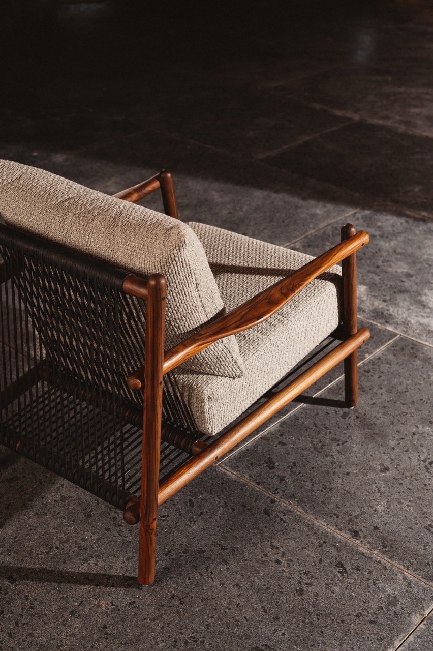 The Doven arm chair pairs reclaimed teak in a natural monocoat finish with leather straps, offering ergonomic comfort