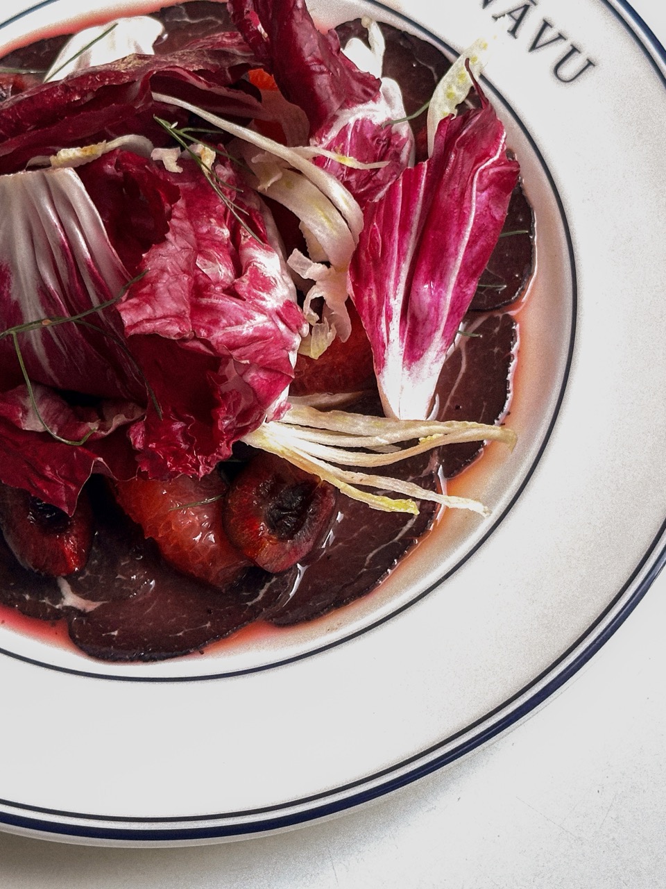 Beetroot Salad, featuring heirloom beets dressed in an onion vinaigrette, served with frisée lettuce and NĀVU boursin
