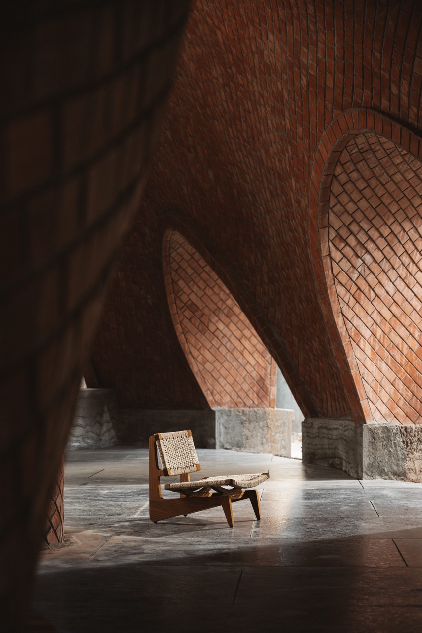 The Poojan chair is a low, graceful seat in reclaimed teak with handwoven Danish cord, offering breathable comfort and ergonomic support for everyday use